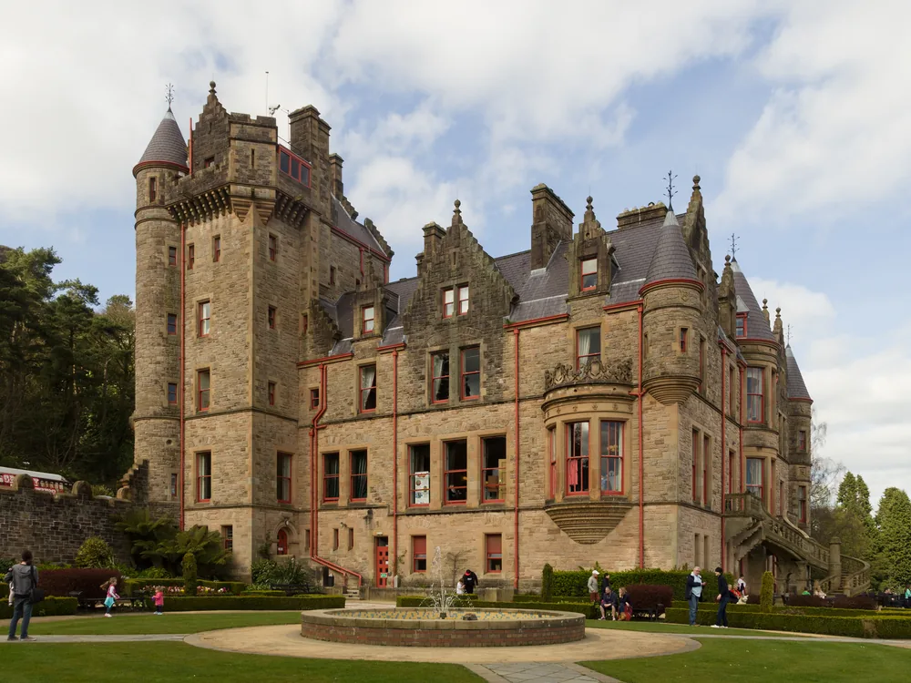 Belfast Castle on the slopes of Cave Hill — the Scottish Baronial Victorian castle with Belfast city and Belfast Lough visible below