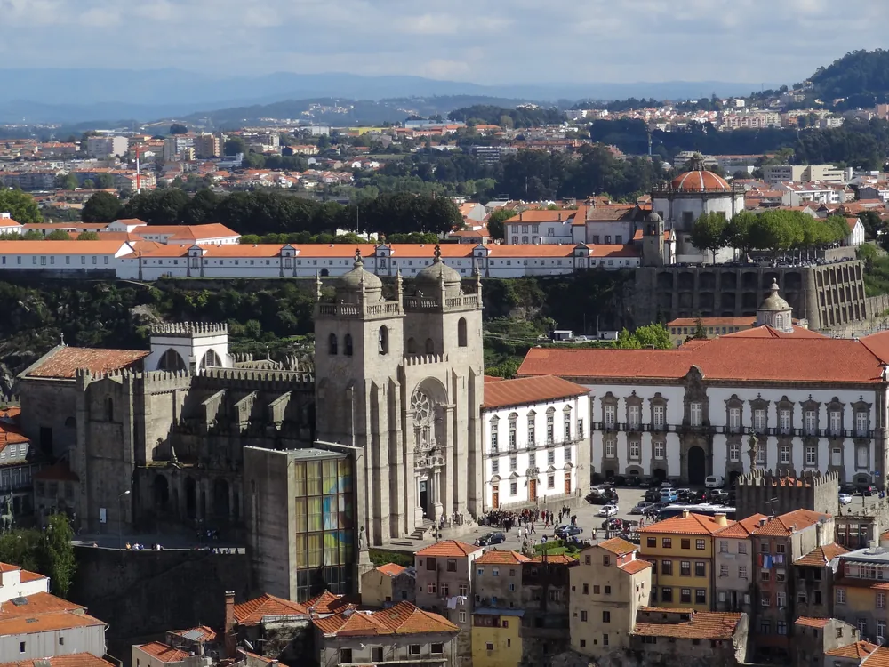 The Bishop's Palace of Porto beside the Sé Cathedral, rising above the historic Ribeira district with the Douro River visible below
