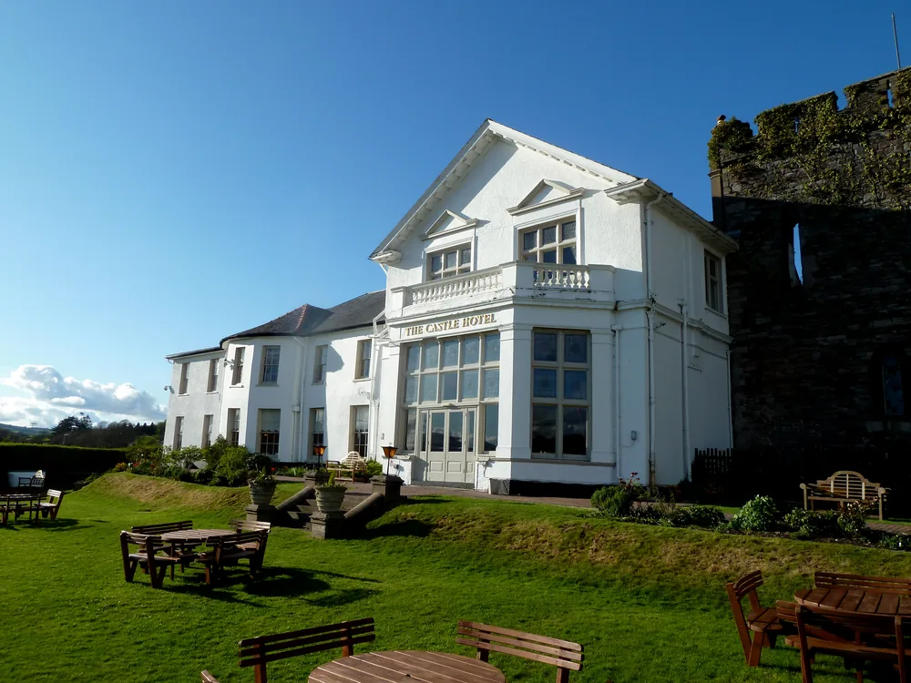 Brecon Castle Hotel beside the ruins of the Norman motte-and-bailey castle in Brecon, Powys, Wales