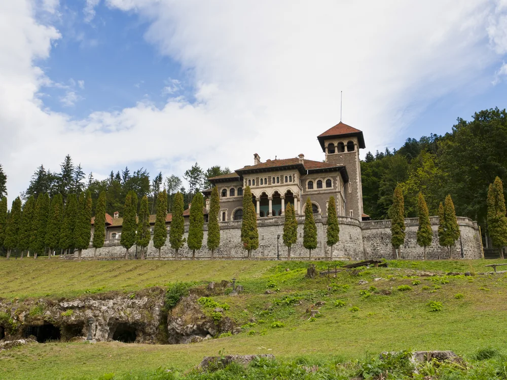 Cantacuzino Castle in Bușteni — Neo-Brâncovenesc towers and terraced gardens below the Bucegi Mountains