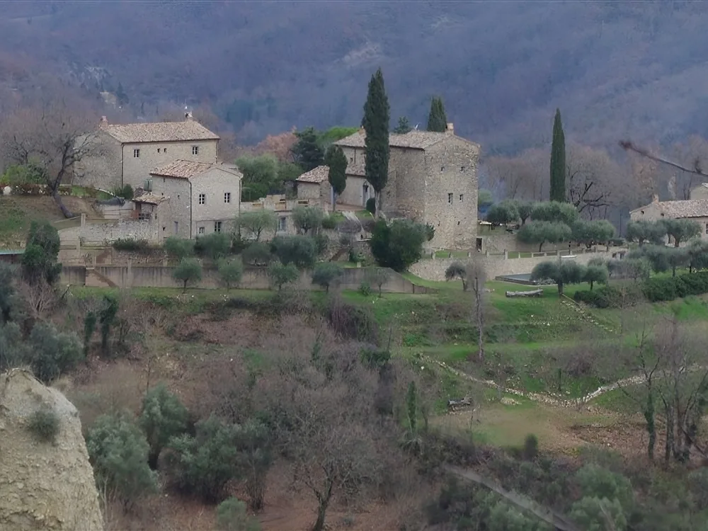 Castello di Cardaneto near Foligno, Umbria — the medieval castle's candlelit hall set for the immersive medieval dinner experience with costumed performers