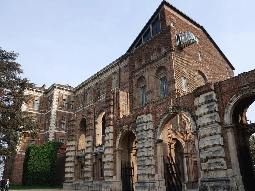 Castello di Rivoli on its hilltop above the Turin plain — Juvarra's completed Baroque pavilion beside the 300-year-old unfinished ruin, Piedmont