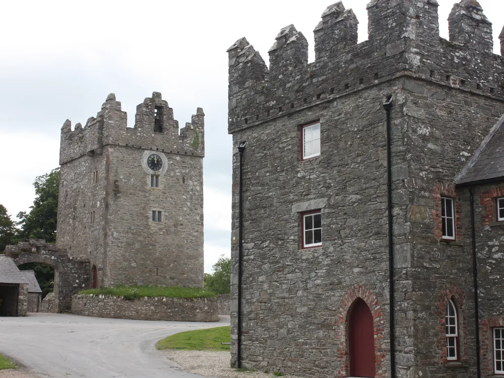 Castle Ward estate in County Down, Northern Ireland — the 18th-century National Trust house with its twin Classical and Gothic facades on Strangford Lough, with the 16th-century tower house farmyard that served as Winterfell's courtyard in Game of Thrones