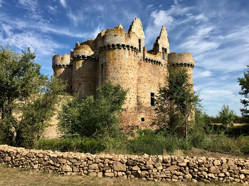 Château de l'Ébaupinay in Deux-Sèvres, France — a 15th-century late Gothic feudal castle with four surviving towers and a partially filled moat