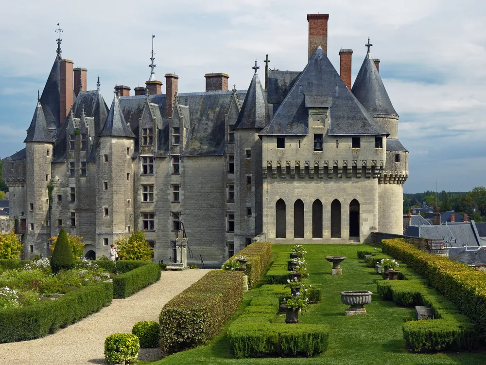 Château de Langeais rising above the town square with its medieval towers and steep slate roofs, Loire Valley, France