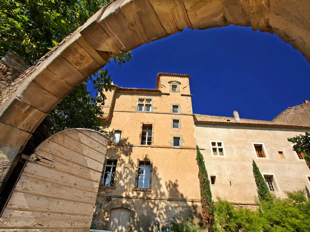 Château de Luc in the Minervois wine country, Languedoc — a 14th-century fortified castle with medieval wine cellar and organic vineyards in the Aude garrigue