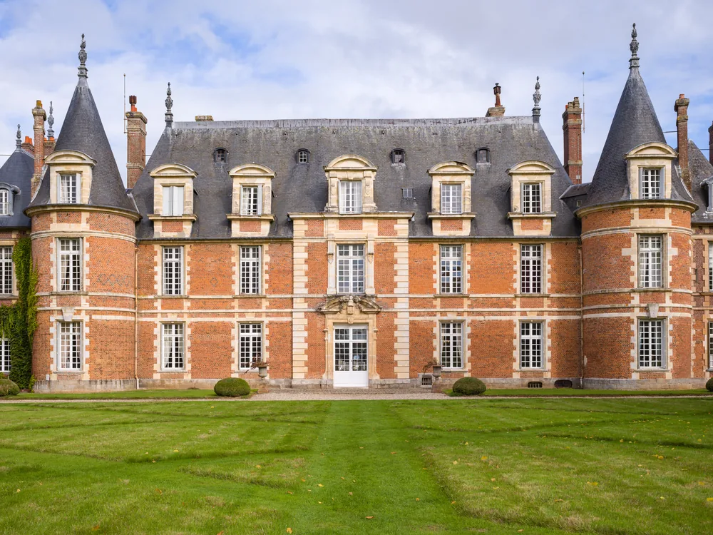 Château de Miromesnil in Tourville-sur-Arques, Normandy — the Louis XIII brick-and-limestone façade and formal parterre gardens of Guy de Maupassant's birthplace in Seine-Maritime