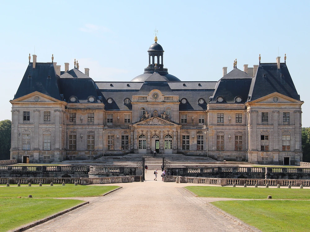 Château de Vaux-le-Vicomte reflected in the grand canal, with Le Nôtre's formal parterres stretching from the château steps to the horizon in Île-de-France