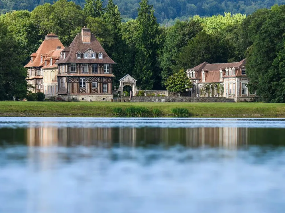 The timber-framed 17th-century manor house of Château du Breuil surrounded by apple orchards in the Pays d'Auge, Normandy