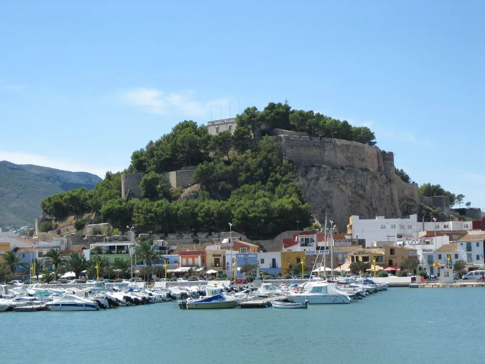 Denia Castle — the multi-period hilltop fortress above the port of Dénia, with views over the Mediterranean, Cap de Sant Antoni, and the Montgó massif in Alicante Province