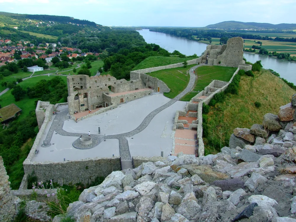 Devín Castle ruins on their rock at the Danube-Morava confluence near Bratislava — the Great Moravian frontier fortress destroyed by Napoleon in 1809, a symbol of Slovak national identity and Cold War Iron Curtain border