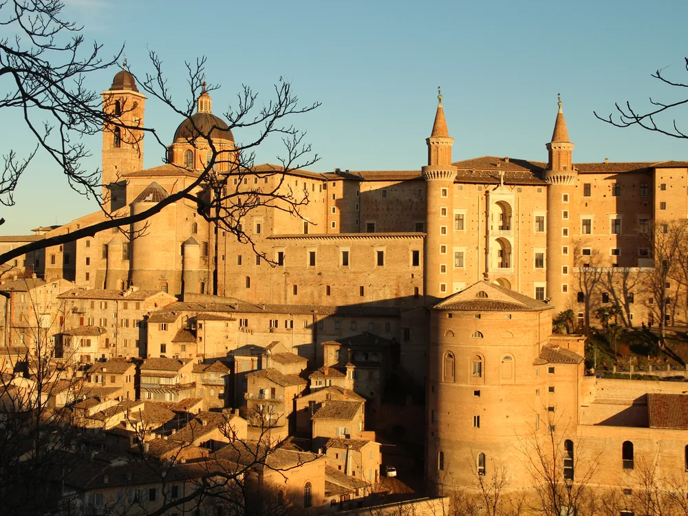 Ducal Palace of Urbino — Federico da Montefeltro's Renaissance palace with its twin cylindrical towers and three-storey loggia facade overlooking the Marche hills, Urbino, Italy