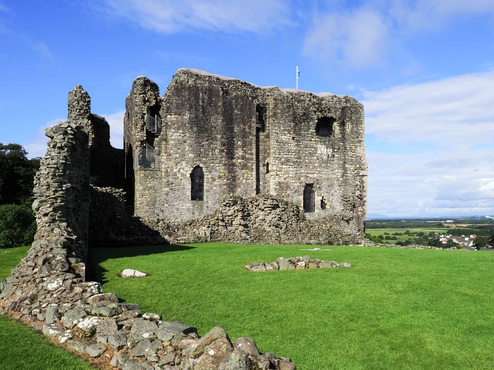 Dundonald Castle ruin rising above the South Ayrshire countryside — the 14th-century seat of Robert II and the founding Stewart kings of Scotland