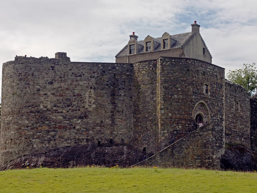 Dunstaffnage Castle on its conglomerate rock promontory above Loch Etive, 3 km north of Oban, Argyll, Scotland — the 13th-century MacDougall curtain-wall castle with the Firth of Lorn beyond