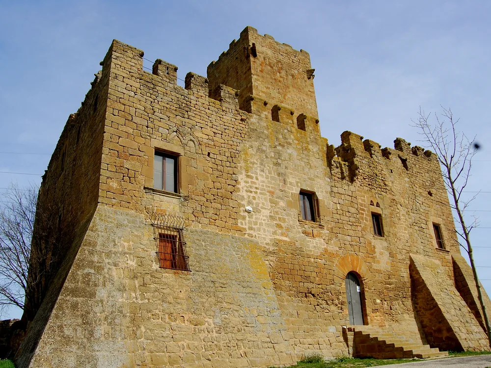 Florejacs Castle in the Segarra, inland Catalonia — a medieval tower and mansion held by the same family for nearly a thousand years, overlooking the rolling wheat fields of Lleida province