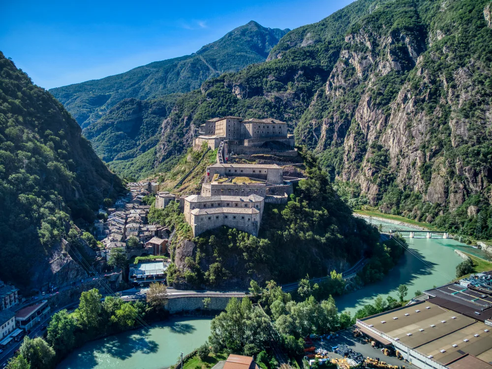 The Fortress of Bard rising in tiers on its rock spur above the Dora Baltea gorge in the Valle d'Aosta, with the Alps beyond