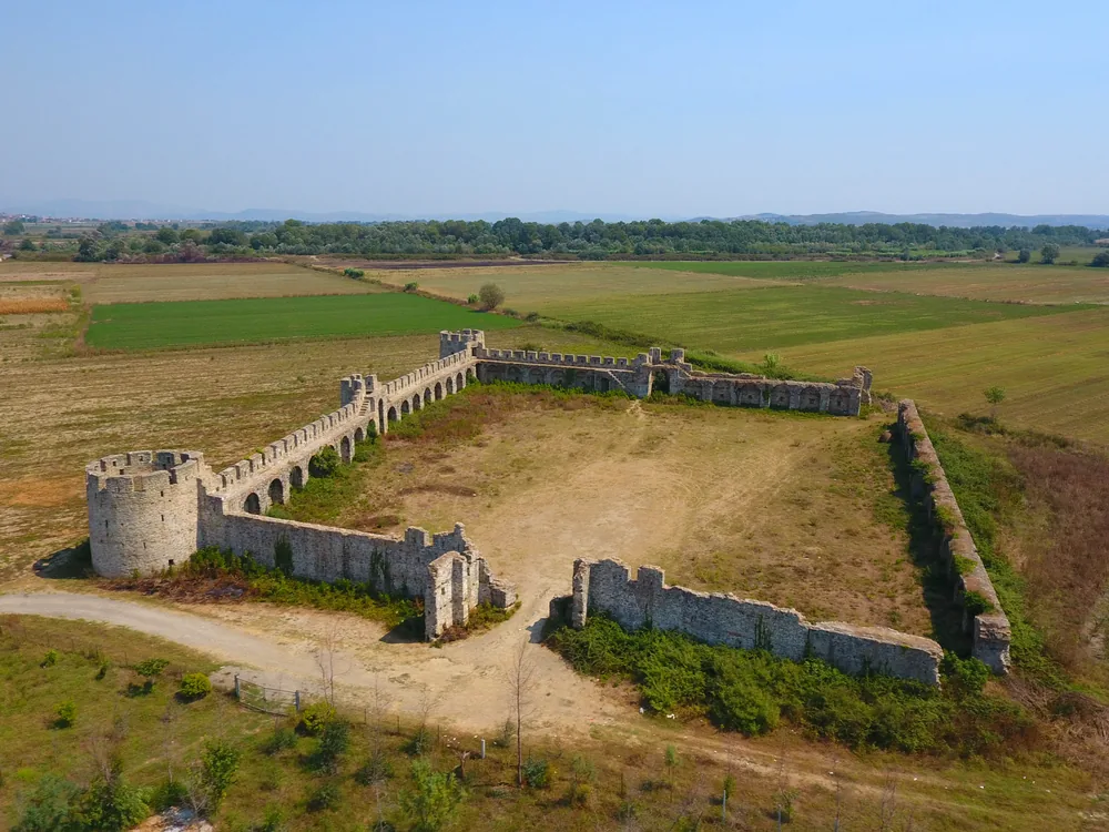 The Fortress of Bashtova rising from the Albanian coastal plain at the mouth of the Shkumbin River — a 15th-century Venetian-Ottoman quadrangular fortress