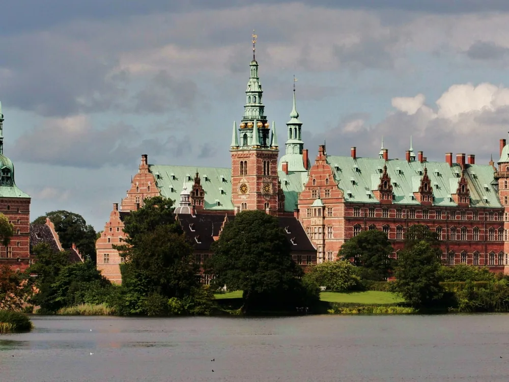 Frederiksborg Palace Dutch Renaissance towers reflected in the lake at Hillerød, Denmark