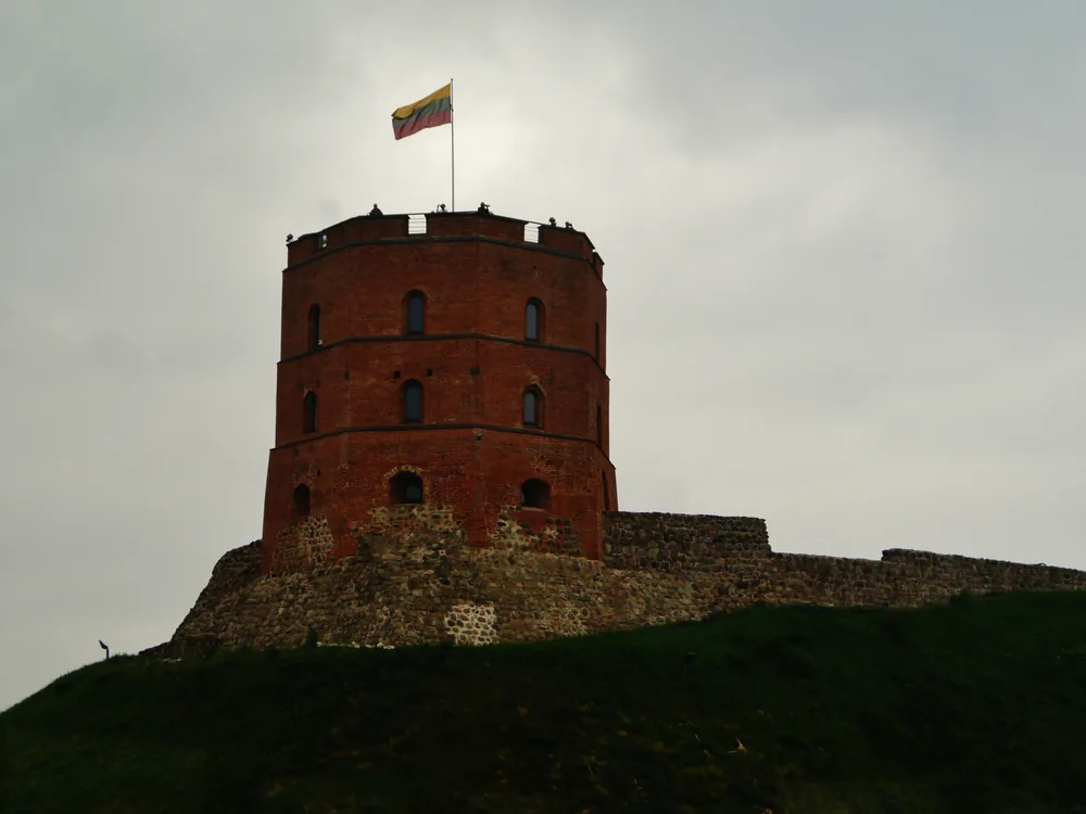 Gediminas Tower above the Vilnius Old Town skyline at sunset in Lithuania