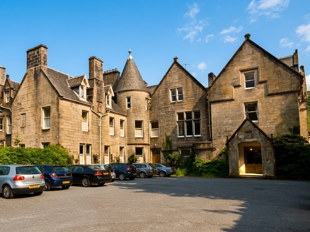 Glengarry Castle Hotel on the shores of Loch Oich in the Great Glen, Scotland, with the ruin of Invergarry Castle on the same estate