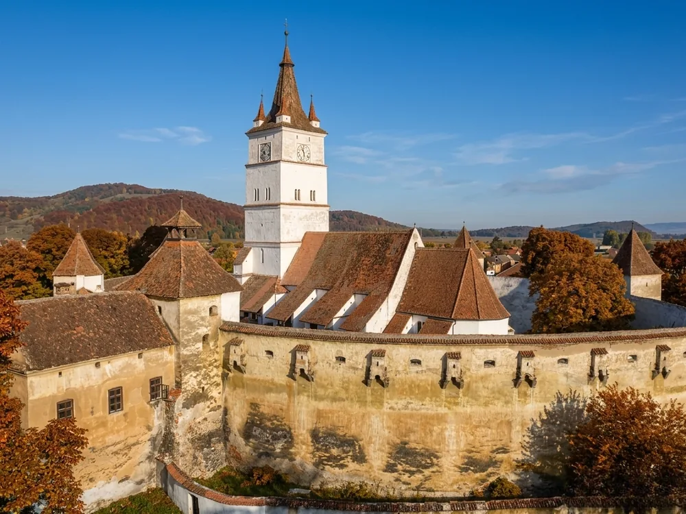 Hărman Fortified Church (Honigberg) in Brașov County, Transylvania, Romania — the Saxon fortified church with its distinctive seven-story bell tower rising above the defensive walls