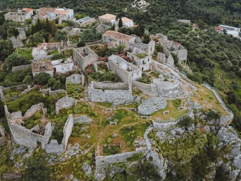 Himara Castle (Kalaja e Himarës) on Barbaka hill above the Albanian Riviera — the 2,600-year-old hilltop castle-town with Ionian Sea and Corfu views, continuously inhabited since ancient Greek times