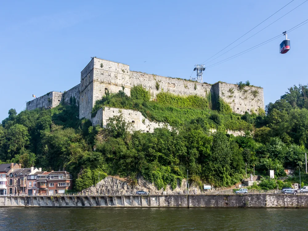 Citadel of Huy (La Citadelle de Huy) on its limestone bluff above the Meuse in Wallonia, Belgium — the 1818–23 Dutch-era star fortress that served as a WWII detention camp, now a memorial museum