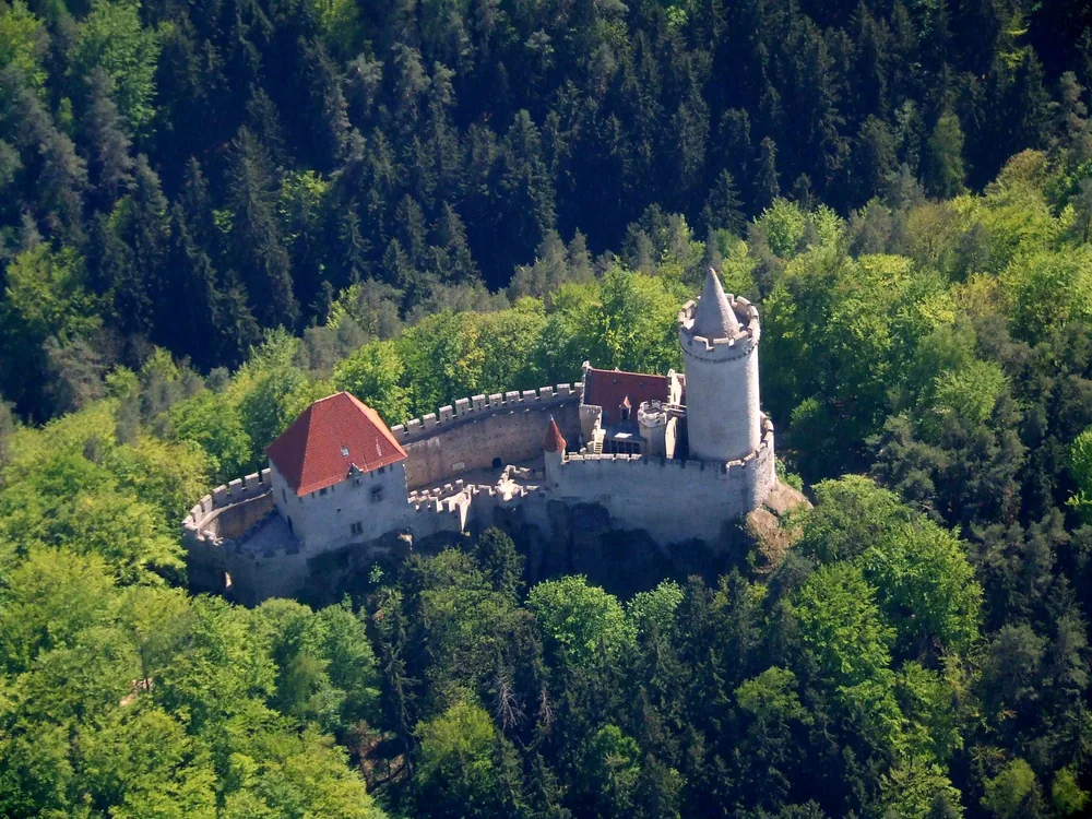 Kokořín Castle on its sandstone ridge in Central Bohemia — the Romantic Gothic restored 14th-century castle above the Kokořínský důl valley in the Kokořínsko Protected Landscape Area