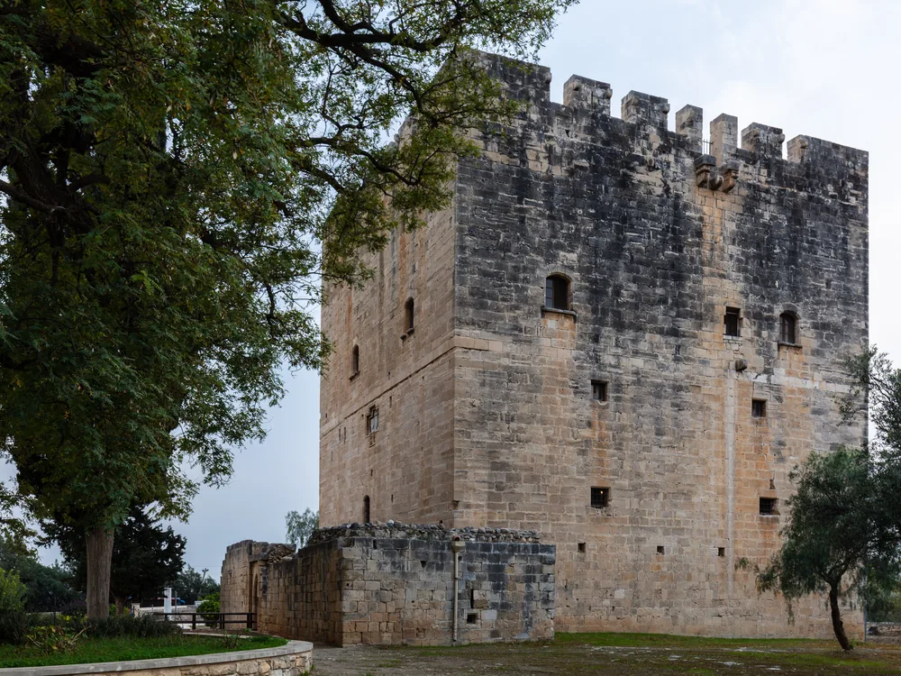 Kolossi Crusader Castle golden limestone tower rising from citrus groves in Cyprus