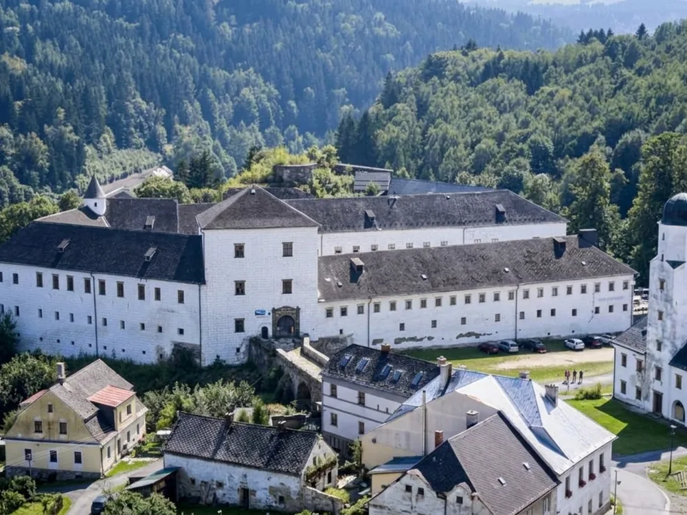 Kolštejn Castle above the Branná river in the Jeseníky foothills, Czech Republic — a Gothic castle rebuilt as a Renaissance château, now a hotel