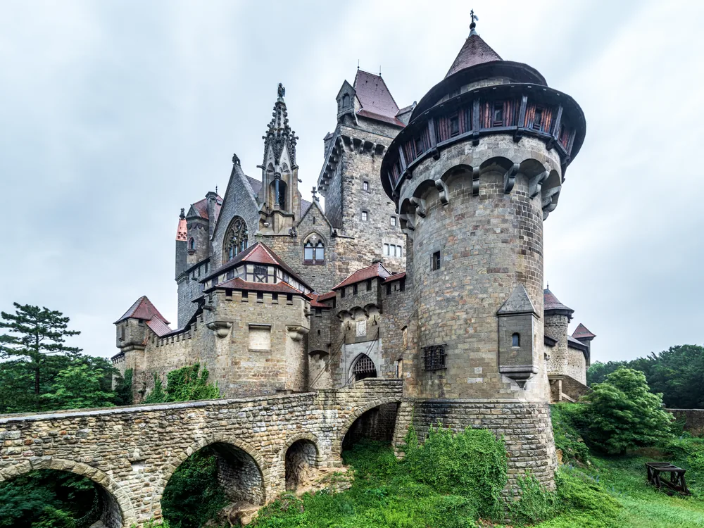 Kreuzenstein Castle (Burg Kreuzenstein) on its limestone ridge above Leobendorf, Lower Austria — the 19th-century romantic reconstruction built with genuine medieval fragments by Count Wilczek, 25 km north of Vienna