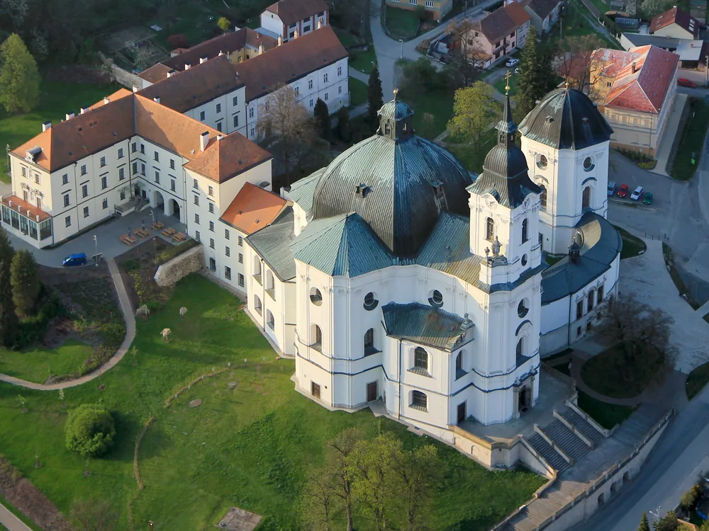 Křtiny Château beside the Santini pilgrimage church in the Moravian Karst, Czech Republic — a Premonstratensian residence rebuilt in the 19th century