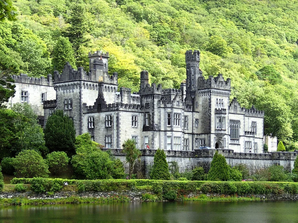 Kylemore Abbey in the Kylemore valley, Connemara, County Galway — Mitchell Henry's 1864–71 Victorian Neo-Gothic castle reflected in Lough Pollacapall, now a working Benedictine abbey