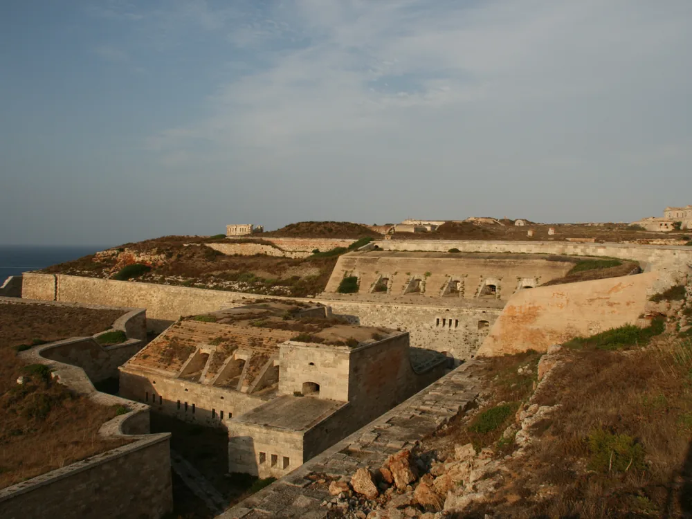 La Mola, Fortress Isabel II on the headland above Menorca's Port of Mahón — the 19th-century Spanish military fortification built to stop British seizure of the island's strategic harbour