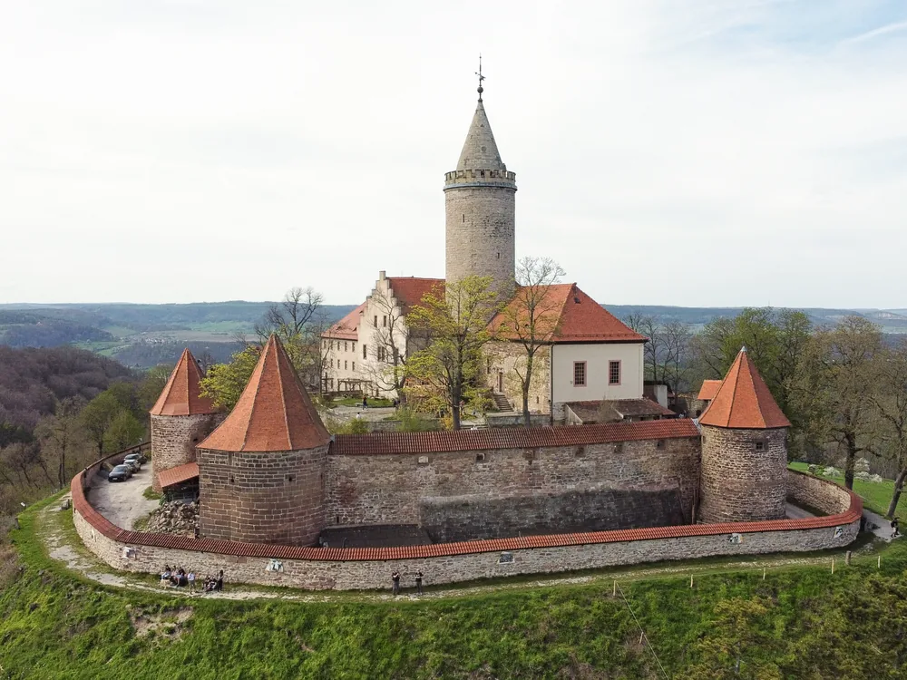 Leuchtenburg Castle on its basalt spur above the Saale valley — the nearly 1,000-year-old Thuringian hilltop castle with the Skywalk of Desires platform, Seitenroda, Thuringia, Germany