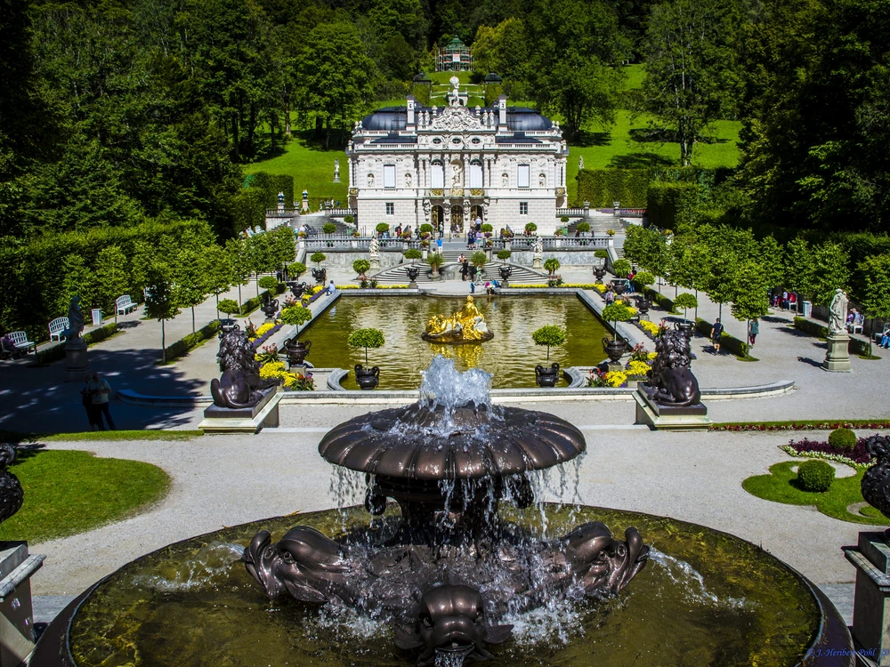 Linderhof Palace's Rococo Revival facade and formal fountain garden set in an Alpine valley near Oberammergau, Bavaria