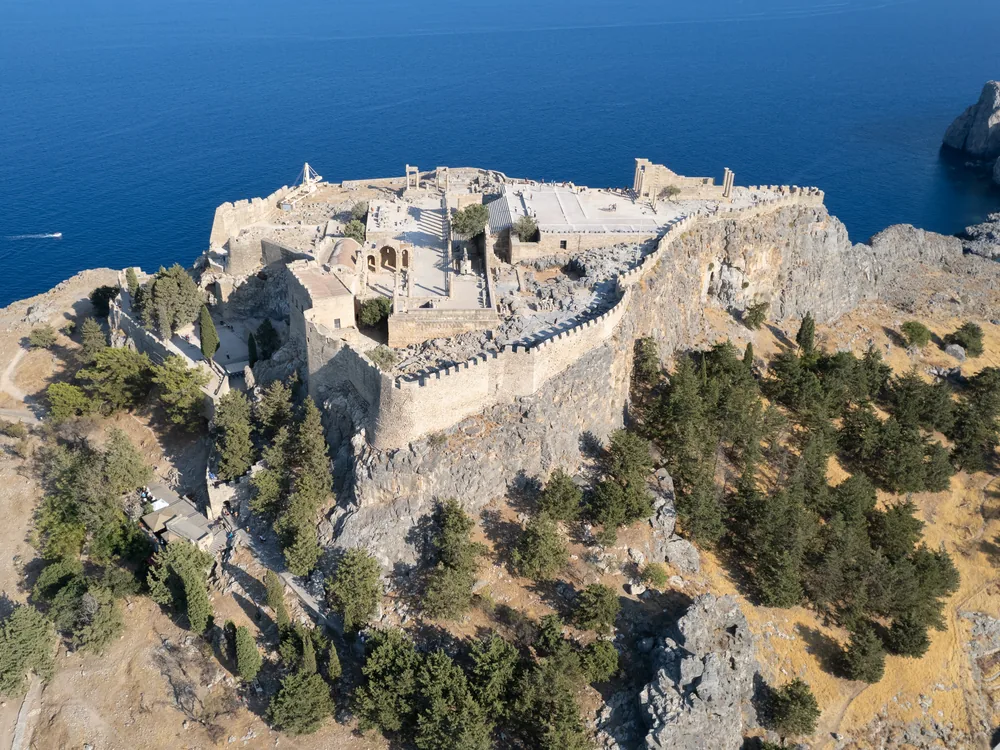 Lindos Acropolis and Knights' Castle above the white village and Aegean bay in Rhodes