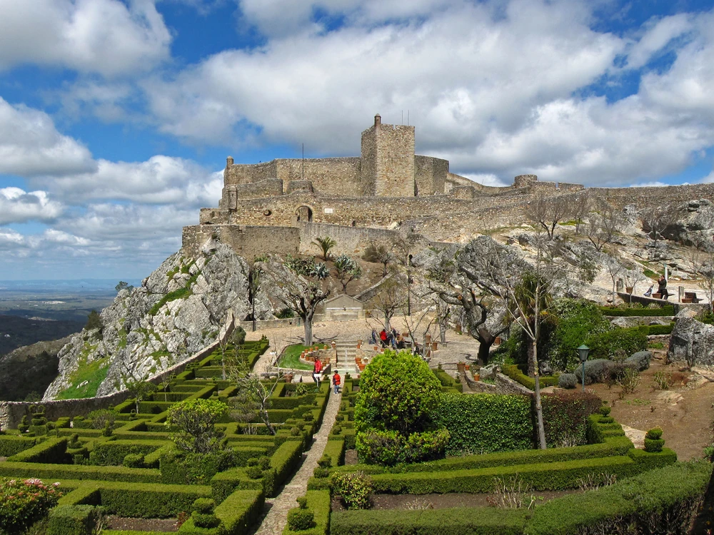 Marvão Castle on its granite clifftop spur at 900 metres, with the Alentejo plain stretching to the horizon