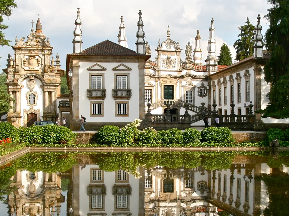 Solar de Mateus (Mateus Palace) reflected in the ornamental pool, Vila Real, Norte Portugal — Nicolau Nasoni's baroque manor palace, the face on the Mateus Rosé wine label, with twin towers and ornate entrance staircase