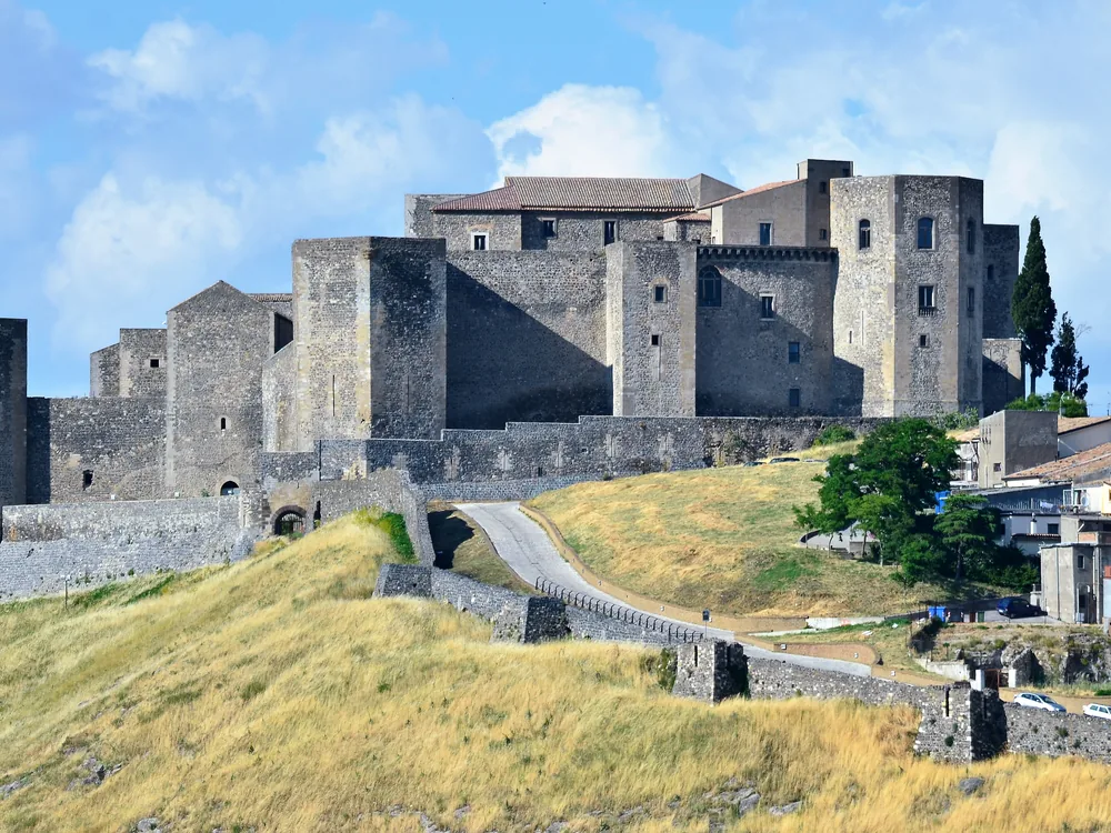 Melfi Castle on the volcanic tuff hill — the 10-towered Norman fortress in Basilicata where Frederick II promulgated the Constitutions of Melfi (1231), now housing the National Archaeological Museum