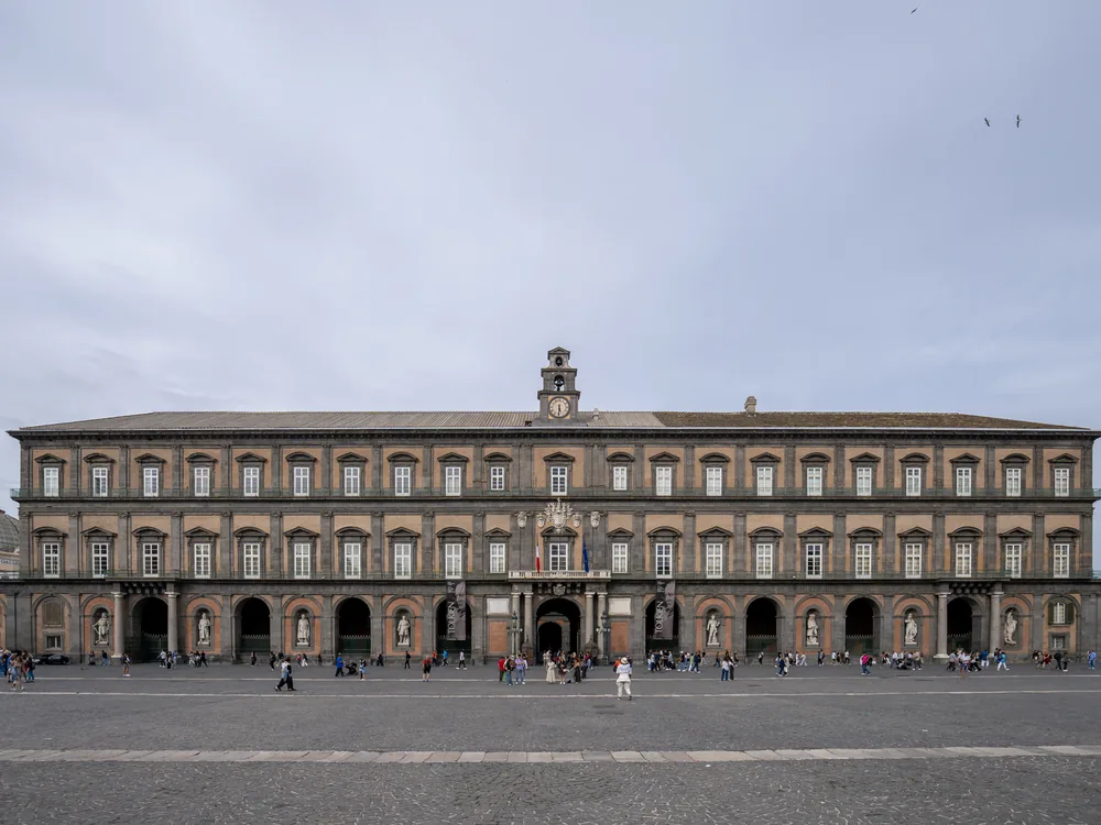 The Naples Royal Palace on Piazza del Plebiscito — the Baroque palace of the Spanish viceroys and Bourbon kings of the Two Sicilies, with eight dynastic statues on its principal facade