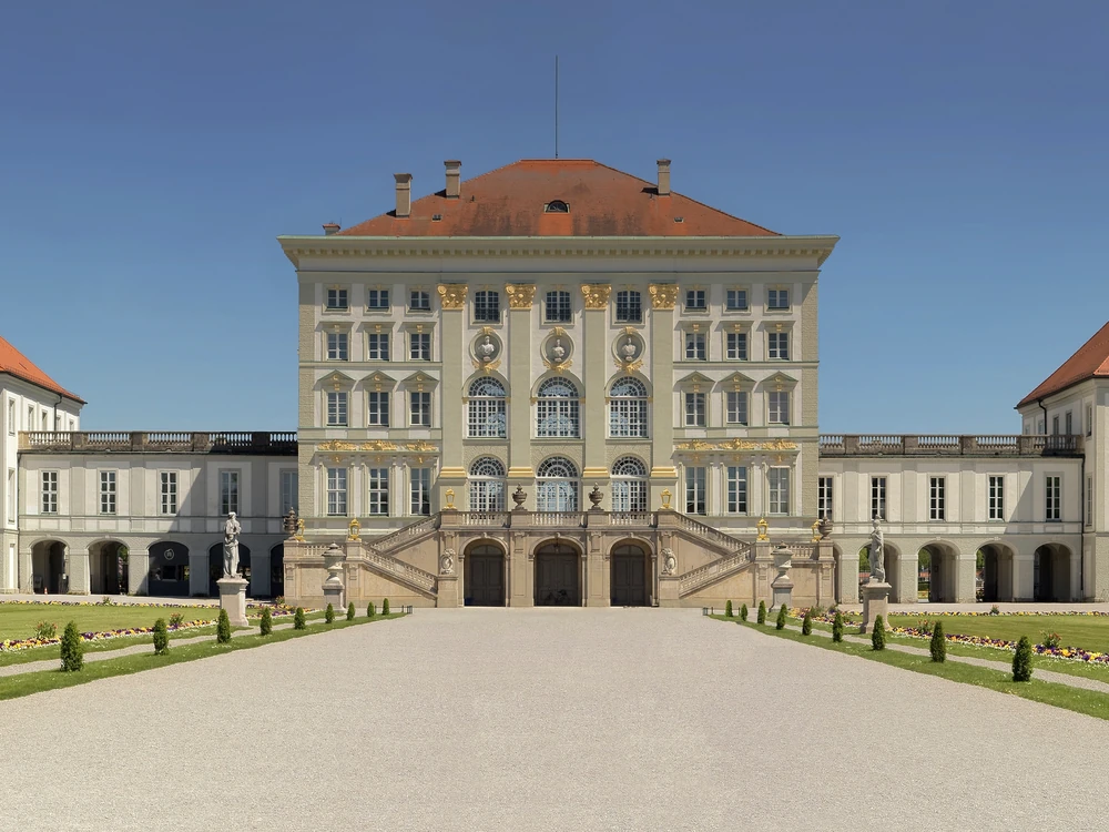 Nymphenburg Palace's wide Baroque facade reflected in its formal canal, Munich, Bavaria