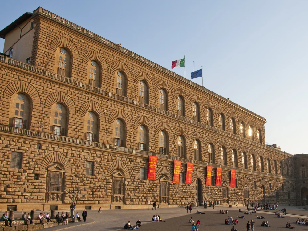 Palazzo Pitti's rusticated Renaissance facade in Florence's Oltrarno district, seen across Piazza de' Pitti