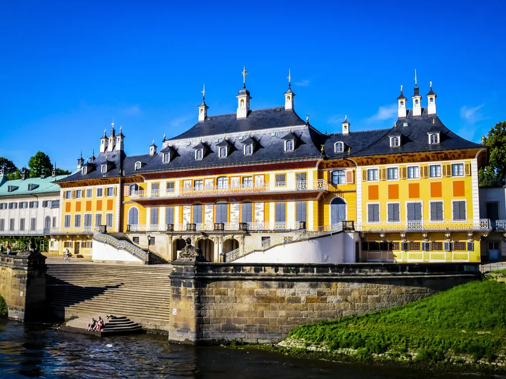 Pillnitz Palace on the Elbe river east of Dresden — the chinoiserie Baroque Wasserpalais of Augustus the Strong, designed by Pöppelmann, with the Elbe embankment and formal garden