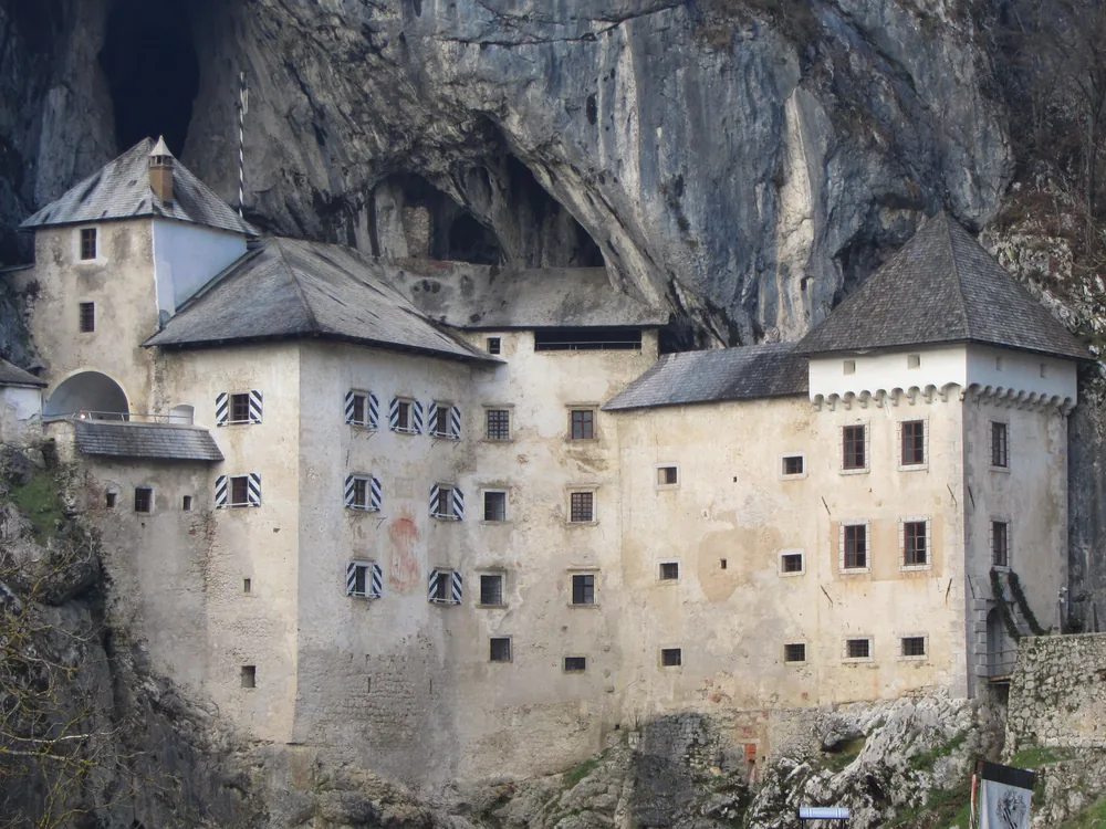 Predjama Castle built into the mouth of a limestone cave in the Karst hills of Slovenia