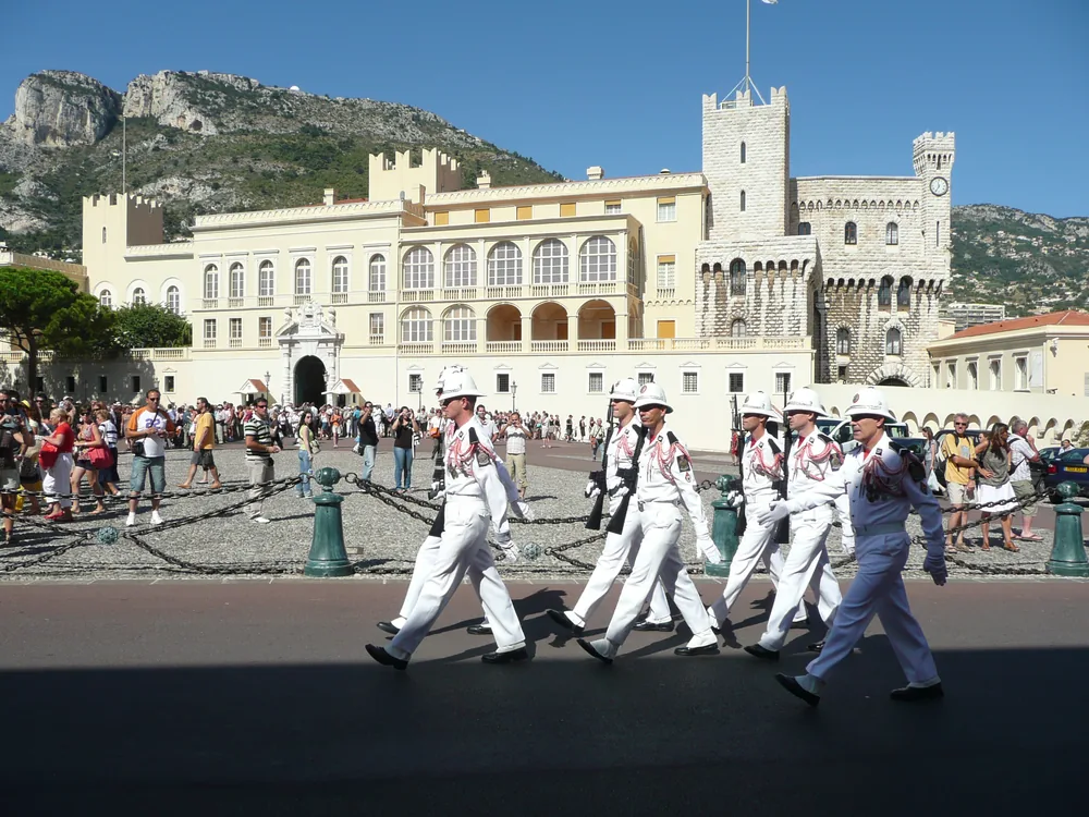 Prince's Palace of Monaco — the Grimaldi dynasty's fortress-palace on Le Rocher, with the crenelated medieval towers and Renaissance Cour d'Honneur visible above the Monaco harbor
