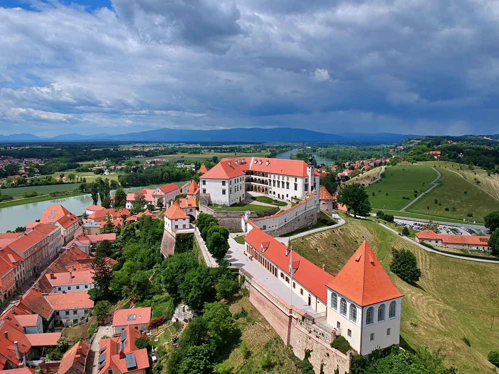 Ptuj Castle on the hill above the medieval rooftops and Drava river valley, Slovenia