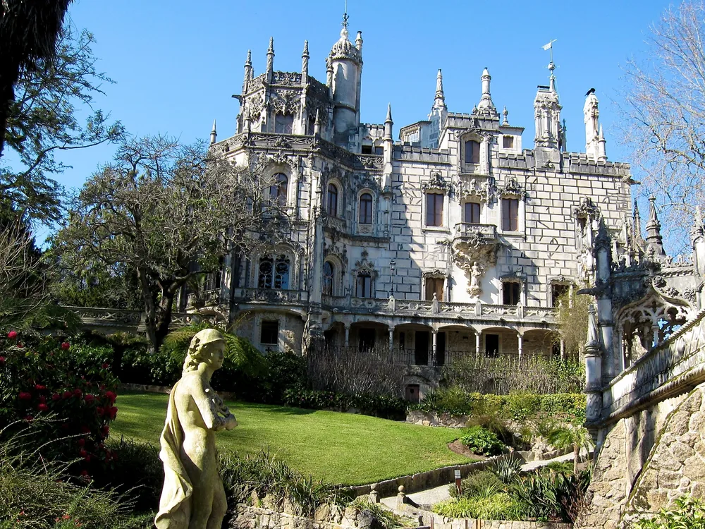 Quinta da Regaleira's Initiation Well — the spiral staircase descending 27 metres through nine platforms into the underground tunnel network, Sintra, Portugal