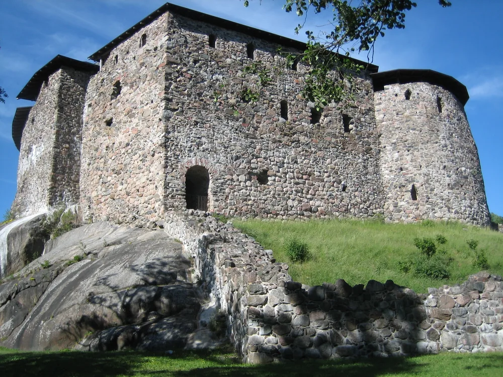 Raasepori Castle ruins on their rocky outcrop in the Finnish coastal landscape near Ekenäs, summer evening light on the medieval stone walls