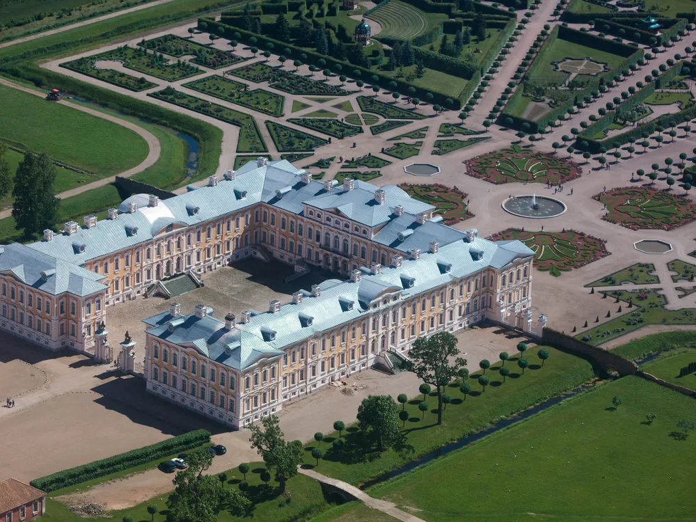 Rundāle Palace in Latvia — Rastrelli's Baroque masterwork for the Duke of Courland, with yellow-ochre facade and restored formal French gardens in the Zemgale countryside